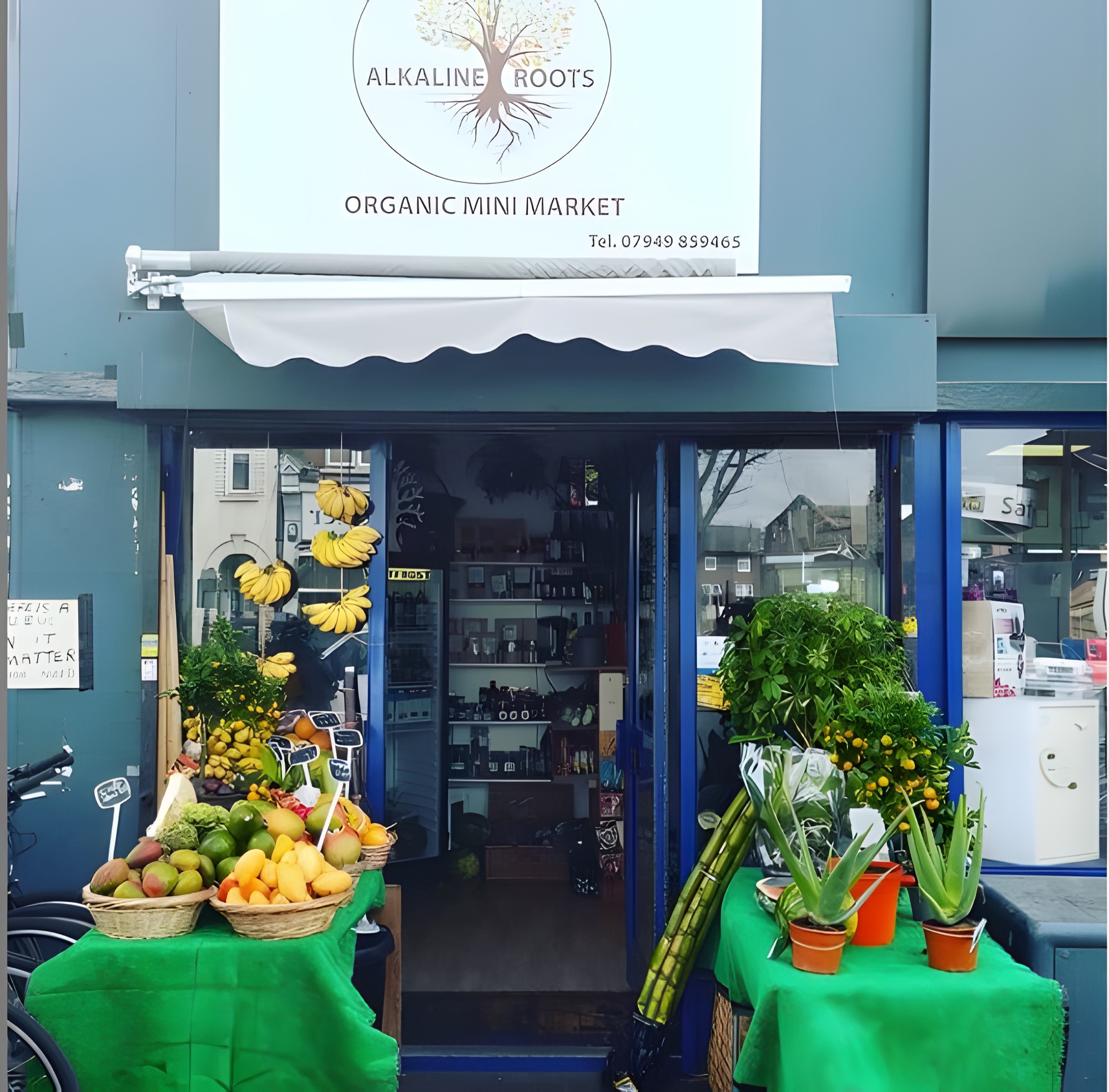 Alkaline Roots Mini-Market storefront on Barking Road with the fruit stand out front