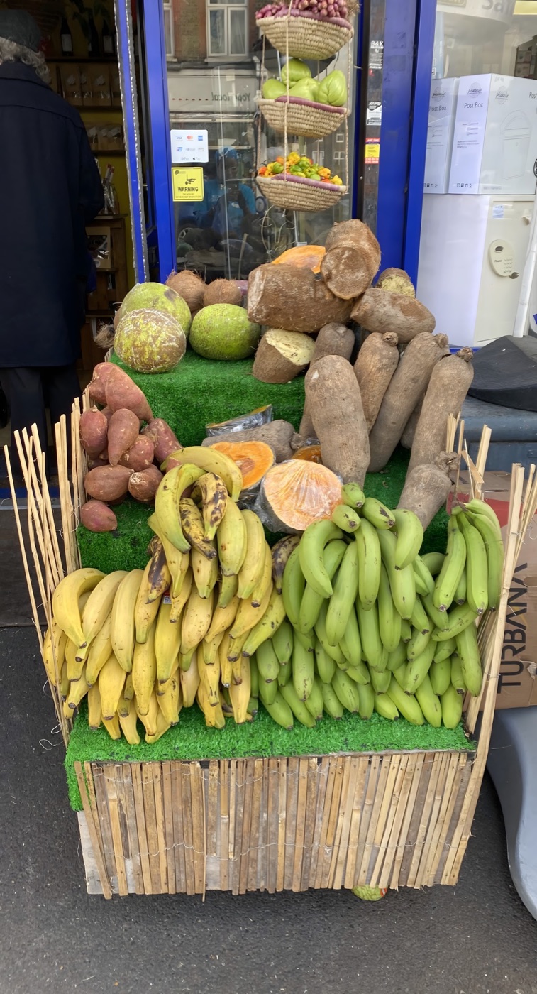 Fresh tropical produce stand outside Alkaline Roots: breadfruit, yam, plantain and bananas